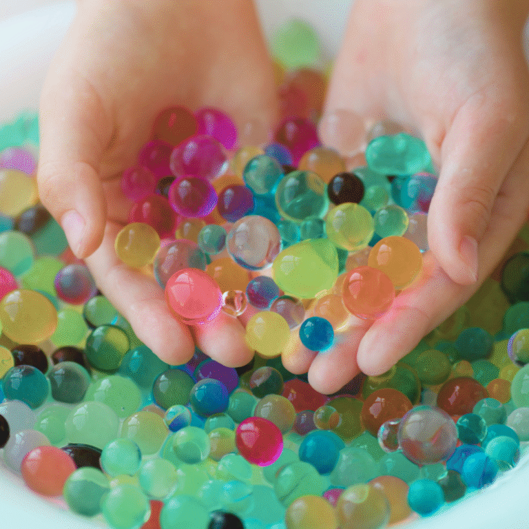 Colorful water beads held in hands, illustrating toys subject to U.S. CPSC water bead safety requirements